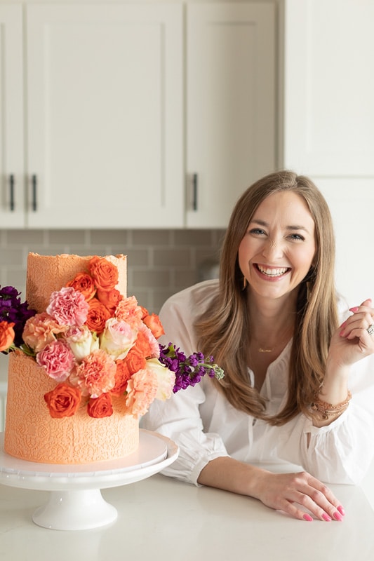 Sarah Campbell with an orange cake she decorated