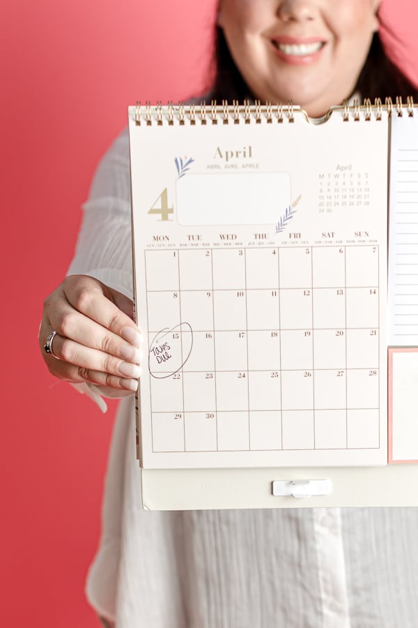 Accountant holding a calendar with April 15 circled for tax day