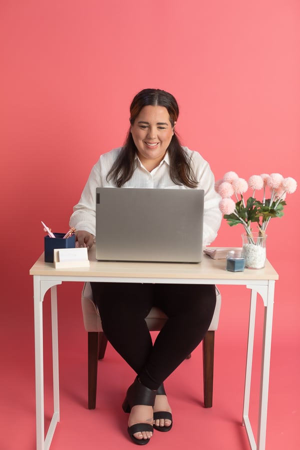 Accountant smiling at a computer while working at a desk